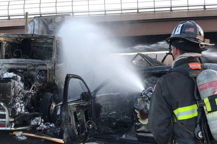 A firefighter works on the scene of a deadly pileup involving over two dozen vehicles near Denver in April 2019. Truck driver Rogel Lazaro Aguilera-Mederos was sentenced last week to 110 years in prison for causing the accident.