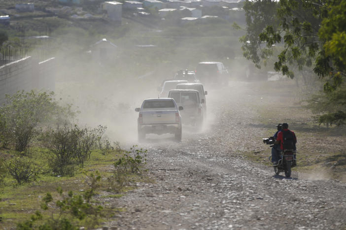 A caravan drives to the airport after departing from the Christian Aid Ministries headquarters at Titanyen, north of Port-au-Prince, Haiti, Dec. 16, 2021.