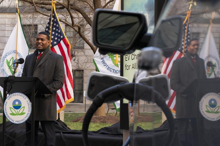 Environmental Protection Agency Administrator Michael Regan is reflected in an electronic vehicle as it charges as he speaks during an event to announce a final rule for federal greenhouse gas emissions standards for cars and trucks on Monday.