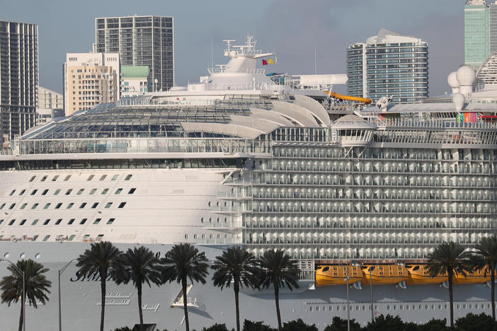 Royal Caribbean's <em>Symphony of the Seas</em> cruise ship, seen docked in Miami in March 2020, saw 48 cases of COVID-19 on its most recent seven-day sailing.