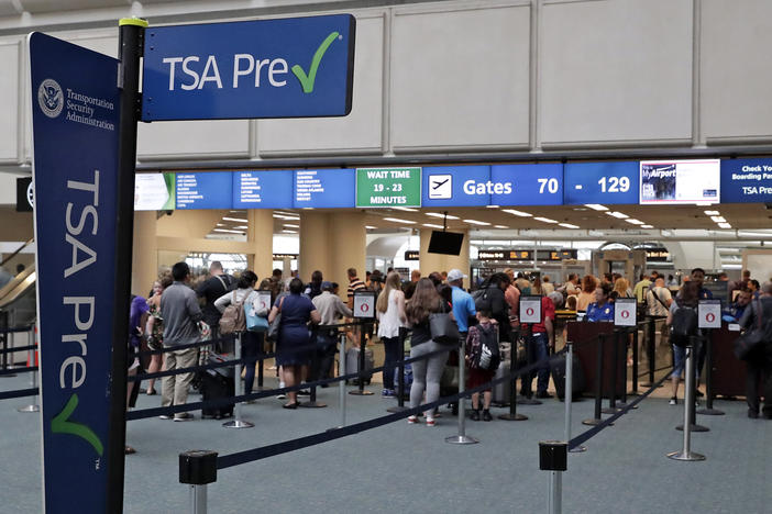 Air passengers heading to their departure gates enter TSA PreCheck at Orlando International Airport. Access to PreCheck could now be revoked for unruly passengers.