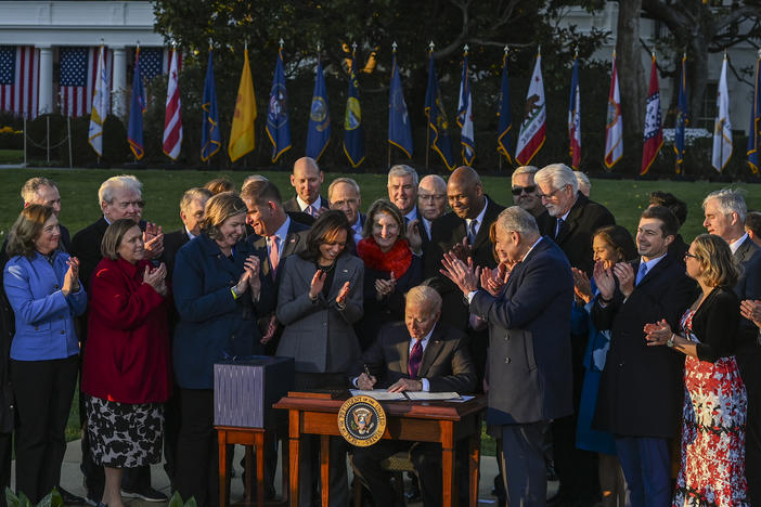 President Biden signs the Infrastructure Investment and Jobs Act, part of Biden's climate plans, in November on the South Lawn at the White House.