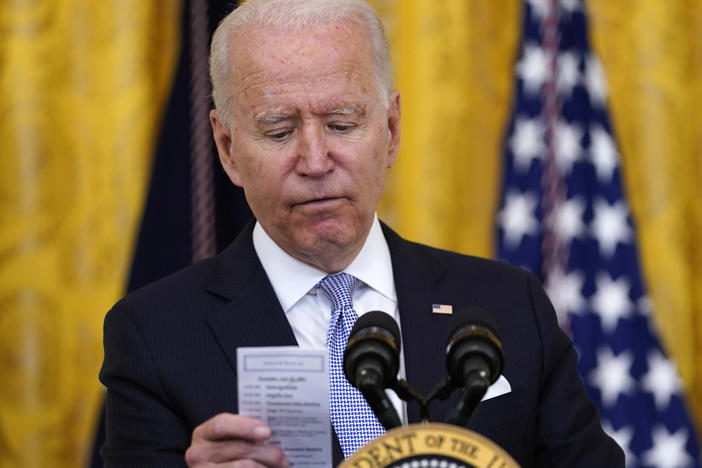President Biden reads the number of COVID-19 deaths from a card he keeps in his pocket on July 29, 2021.