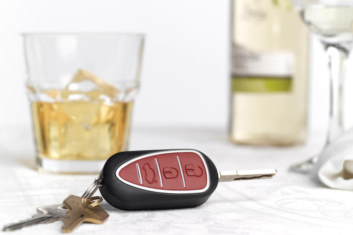 Car keys are shown by glasses with alcohol in this stock photo illustration. Companies are developing technology that would allow cars to stop people from driving when drunk.