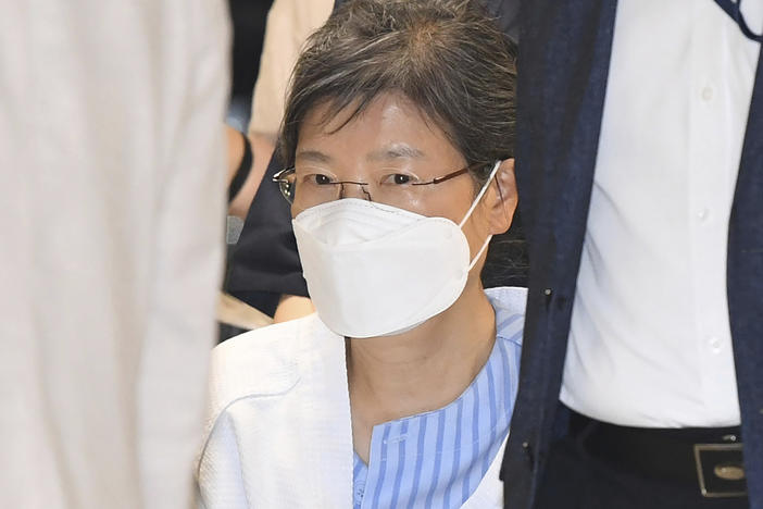 Former South Korean President Park Geun-hye arrives at a hospital in Seoul, on July 20, 2021. The government says it will grant a special pardon to Park, who is serving a lengthy prison term for a series of corruption charges.