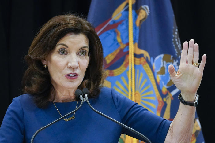 New York Gov. Kathy Hochul shortened the quarantine period for many essential workers even as infections have surged because of the omicron variant.