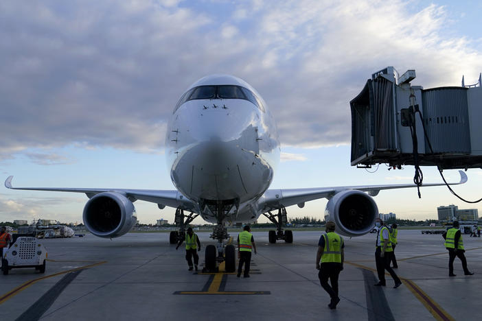 A Lufthansa flight arrives at Miami International Airport last month. The German airline, along with United and Delta, reported canceling dozens of Christmas Eve departures as illnesses tied to the omicron variant of COVID-19 take a toll on flight crew.