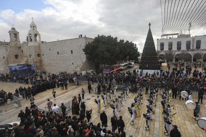 Palestinian scout bands parade through Manger Square at the Church of the Nativity, traditionally believed to be the birthplace of Jesus Christ, during Christmas celebrations, in the West Bank town of Bethlehem on Friday.