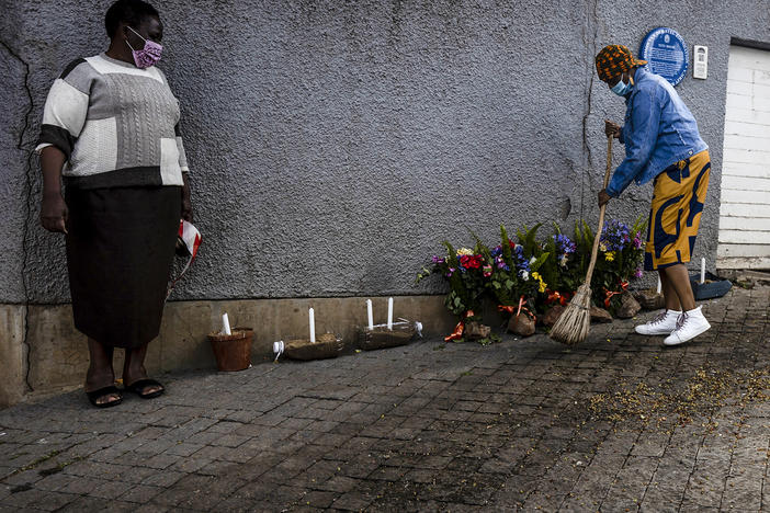 A woman sweeps outside the house where Desmond Tutu lived in Soweto, South Africa. Tutu, South Africa's Nobel Peace Prize-winning activist for racial justice and LGBT rights and retired Anglican Archbishop of Cape Town, has died.