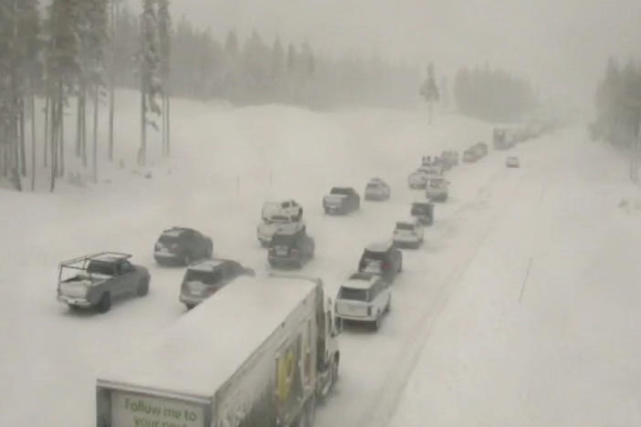 In this image taken from video from a Caltrans remote video traffic camera, vehicles are backed up on a snow-covered Interstate 80 at Donner Summit, Calif., on Thursday. Snow continued over the Christmas weekend in the area.