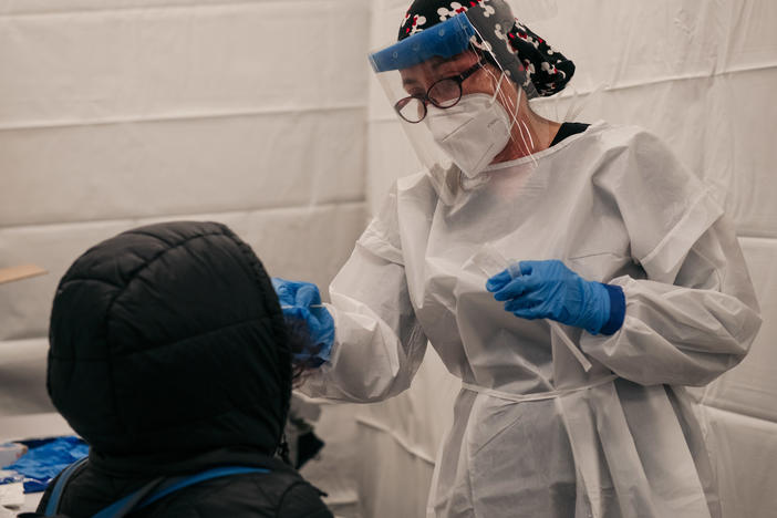 A medical worker administers a coronavirus test at a new testing site at the Times Square subway station in New York City on Monday.