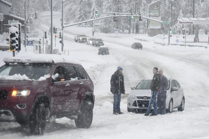 Stuck motorists are seen along Brunswick Road as heavy snow continues to fall early Monday, in Grass Valley, Calif.