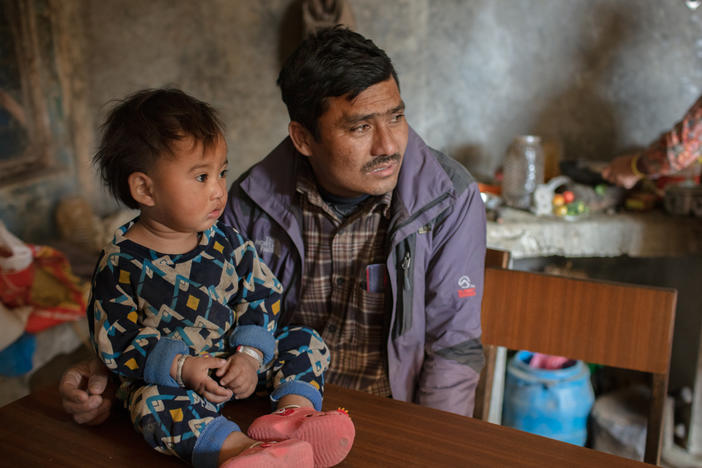 Married at 15, Chakraman Shreshta Balami fulfilled his dying father's wish by getting married — at age 15. He had to give up his dream of becoming a doctor. Now the vice principal of Sri Bhavani government school, he campaigns against child marriage — but even his son was married as a teenager. Above, he poses with a grandchild.