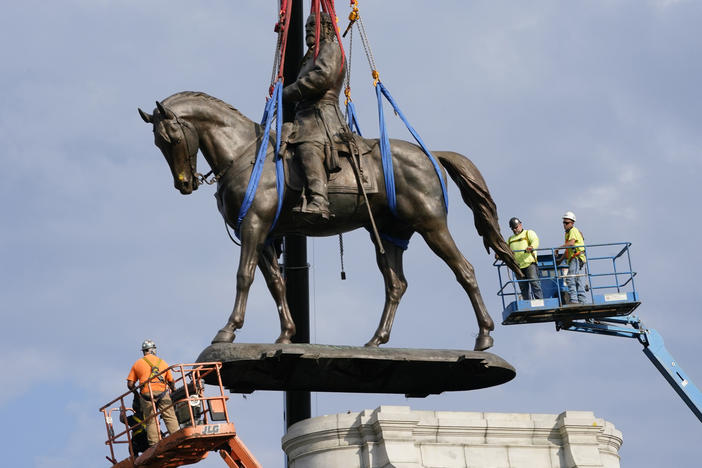 Crews remove the statue of Robert E. Lee in Richmond on Sept. 8. Pending city council approval, the statue and eight other Confederate monuments will be moved to Richmond's Black History Museum.