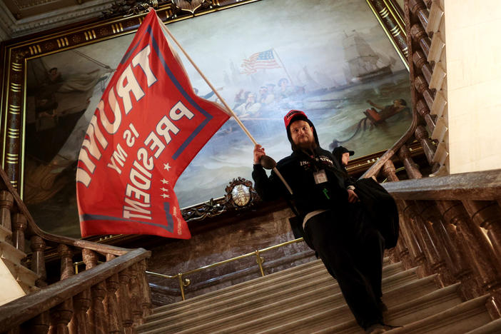 A protester holds a Trump flag inside the U.S. Capitol near the Senate Chamber.