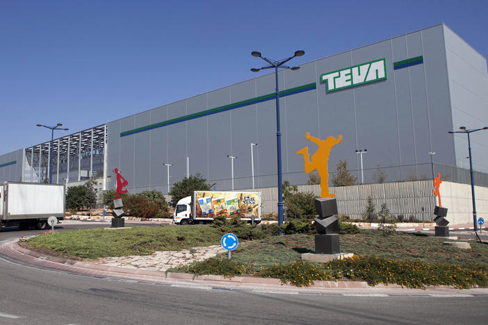 Trucks drive in front of Teva Pharmaceutical Logistic Center in the town of Shoam, Israel, on Oct. 16, 2013. On Thursday, a jury held Teva responsible for contributing to the opioid crisis.