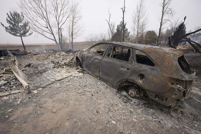 Damage to homes burned by wildfires after they ripped through a development are shown Friday in Superior, Colo.