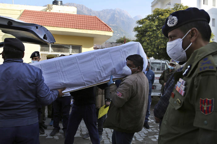 Health workers carry the coffin of a victim who died Saturday in a stampede at the Mata Vaishnav Devi shrine in Indian-controlled Kashmir.