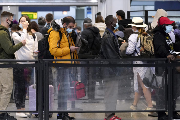 Travelers line up for flights at O'Hare International Airport in Chicago on Thursday.