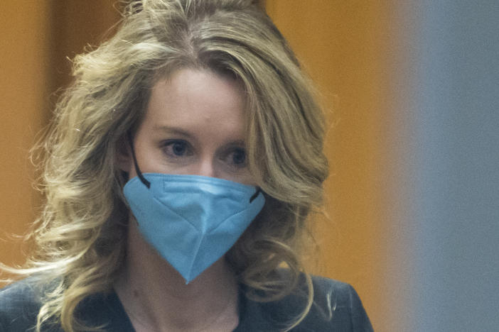 Elizabeth Holmes walks into federal court in San Jose, Calif.