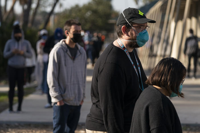 People wait in line for a coronavirus test in Los Angeles on Tuesday. California is starting to feel the full wrath of the omicron variant. Hospitalizations have jumped nearly 50% since Christmas and models show that in a month, the state could have 22,000 people in hospitals, which was the peak during last winter's epic surge.