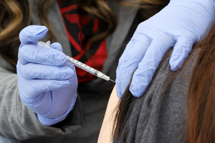 A woman receives a booster shot at a pop-up vaccination clinic in Las Vegas on Dec. 21.