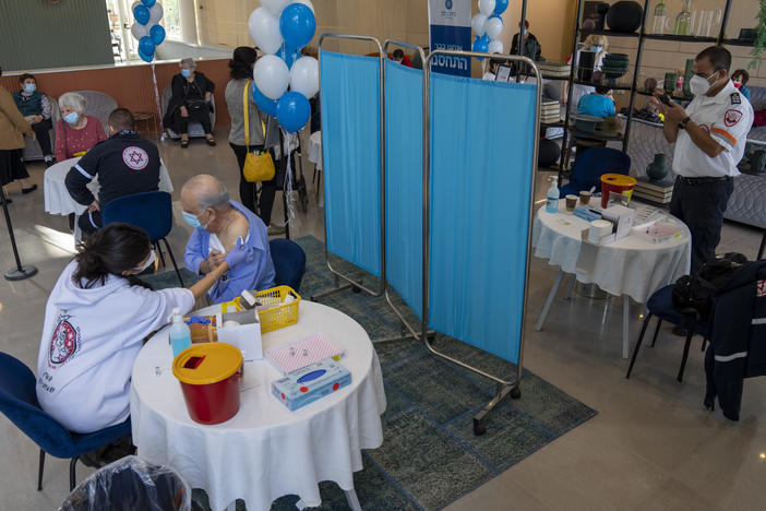 A man receives his fourth dose of the coronavirus vaccine in a private nursing home in Petah Tikva, Israel, on Tuesday.