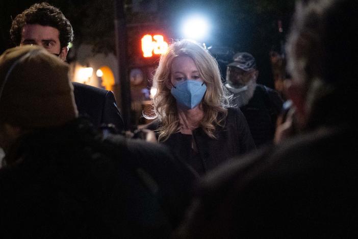 Elizabeth Holmes and partner Billy Evans walk outside the federal court in San Jose, California on January 3.