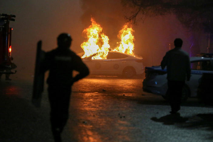 A police car on fire during a protest in Almaty on Wednesday.