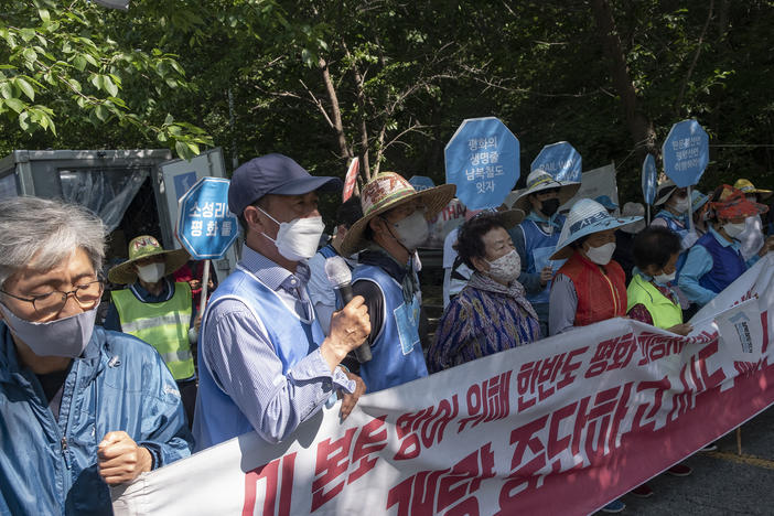 Activists demonstrate against a U.S. missile defense system installed in Seongju county, South Korea, since 2017. Protesters stand near the entrance of the base, the site of a former golf course.