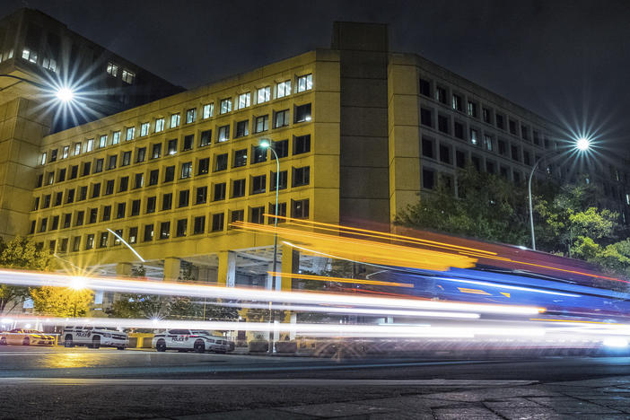 In this Nov. 1, 2017, file photo traffic along Pennsylvania Avenue in Washington streaks past the Federal Bureau of Investigation headquarters building.