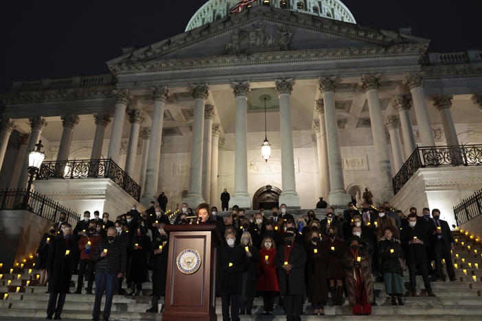 House Speaker Nancy Pelosi, D-Calif., pauses for a moment of silence alongside fellow lawmakers and congressional staff members during a vigil Thursday evening to commemorate the anniversary of the Jan. 6 attack on the U.S. Capitol.
