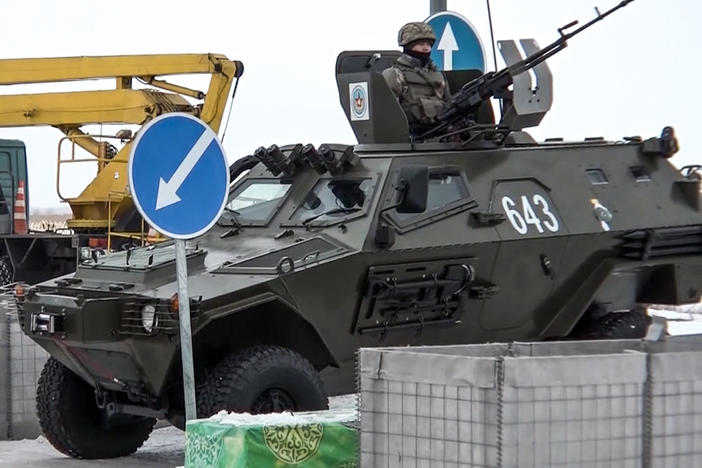 A Kazakh soldier stands next to a military vehicle at a check point in Kazakhstan on Friday.