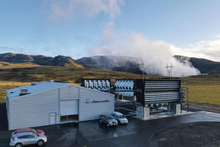 Climeworks factory with it's fans in front of the collector, drawing in ambient air and release it, as largely purified CO2 through ventilators at the back is seen at the Hellisheidi power plant near Reykjavik on October 11, 2021.