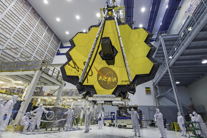 Technicians lift the mirror of the James Webb Space Telescope using a crane at the Goddard Space Flight Center in Greenbelt, Md., in April 2017. On Saturday, the telescope completed its final deployment in space.