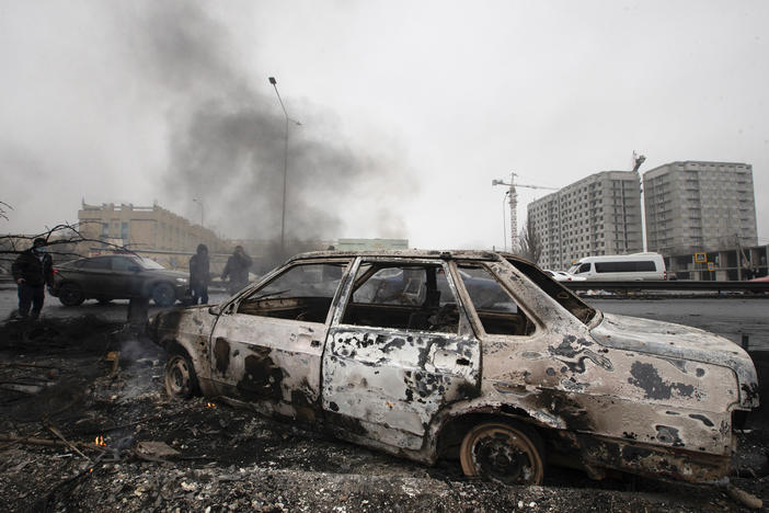 A car, which was burned after clashes, is seen on a street in Almaty, Kazakhstan, on Friday.