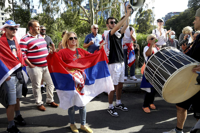 Protesters and fans of Novak Djokovic gather outside the Park Hotel, used as an immigration detention hotel where Djokovic is confined in Melbourne, Australia, on Saturday.