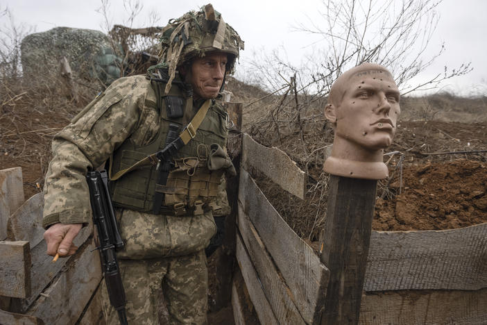 A Ukrainian soldier walks in a trench at the line of separation from pro-Russian rebels in the Donetsk region of Ukraine on Sunday.