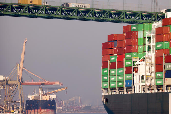 Trucks cross the Vincent Thomas Bridge above a container ship at the Port of Los Angeles on Nov. 30, 2021. Transportation, particularly for moving freight to meet high demand for consumer products, saw the steepest increase in climate-warming emissions in 2021.
