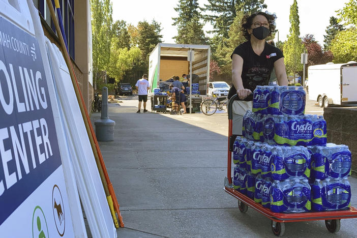 A volunteer helps set up snacks at a cooling center established  to help vulnerable residents ride out the second dangerous heat wave to grip the Pacific Northwest last summer, on Aug. 11, 2021.