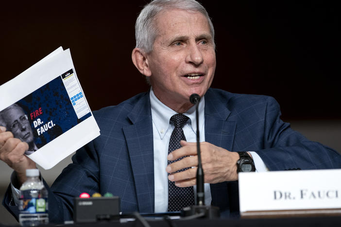 Dr. Anthony Fauci, director of the National Institute of Allergy and Infectious Diseases and chief medical adviser to the president, holds up printouts from Sen. Rand Paul's reelection campaign website.