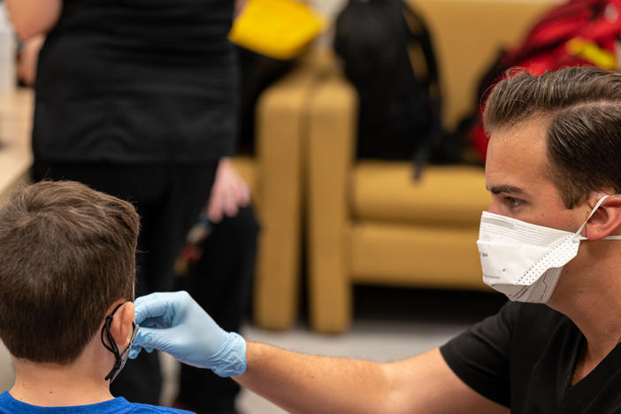A student is administered a coronavirus test at an elementary school in Louisville, Ky.