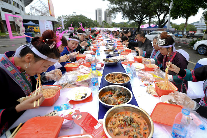 Above: locals in Liuzhou feast on their regional specialty of snail noodles. The novelty of the dish has made it a viral sensation in China during the pandemic.