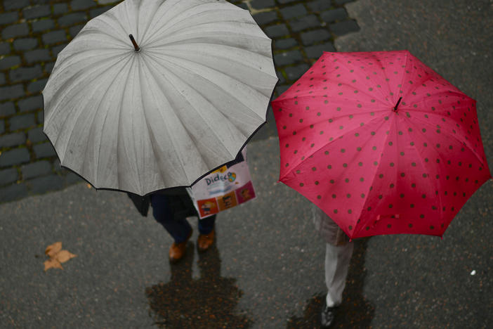 People shelter from the rain under their umbrellas as rain falls in Pamplona, northern Spain, in 2018.