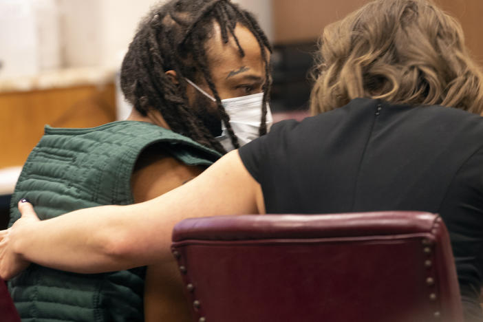 Darrell Brooks, left, speaks with a lawyer during a court appearance on Nov. 23, 2021 in Waukesha County Court in Waukesha, Wis. Brooks is now facing new charges related to the Christmas parade tragedy.