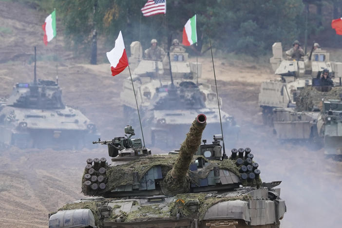 Military vehicles and tanks of Poland, Italy, Canada and United States roll during the NATO military exercises ''Namejs 2021'' at a training ground in Kadaga, Latvia, Sept. 13, 2021.