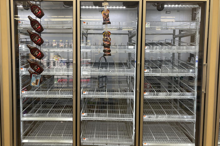 The milk shelf is mostly empty at a Giant grocery store on Tuesday in Washington, D.C.