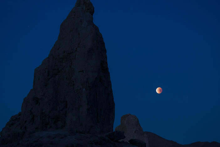 A lunar eclipse viewed from California's Trona Pinnacles Desert National Conservation Area. Scientists believe there may be more moons in the galaxy than planets.