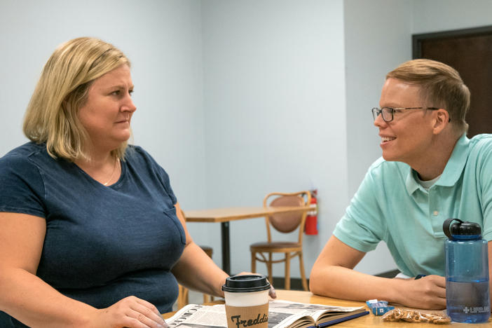 Sam (Bridget Everett) and Joel (Jeff Hiller) bond over student essays in <em>Somebody Somewhere</em>.