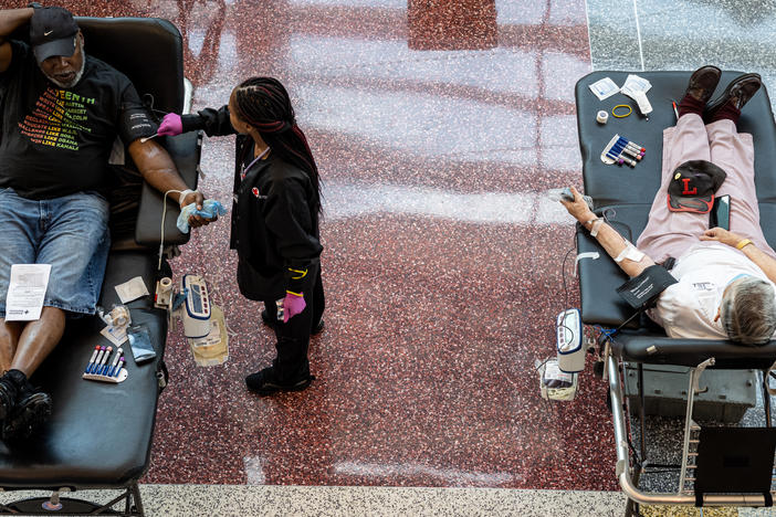 A phlebotomist tends to a blood donor during the Starts, Stripes, and Pints blood drive event in Louisville, Ky., in July. Rising numbers of organ transplants, trauma cases, and elective surgeries postponed by the COVID-19 pandemic have caused an increase in the need for blood products.